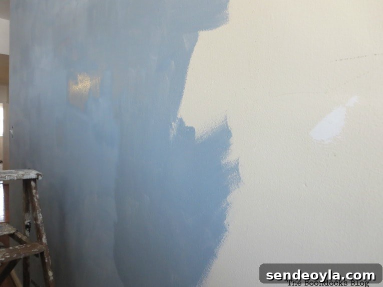 How to Paint a Cloud Accent Wall: DIY Step-by-Step Guide 6 First coat of paint going on the wall.