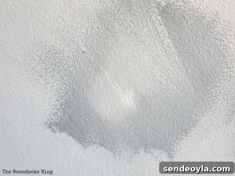 How to Paint a Cloud Accent Wall: DIY Step-by-Step Guide 9 A swatch of dark paint with white added on top to look like a cloud.
