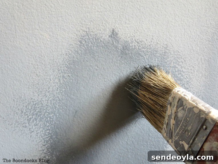 How to Paint a Cloud Accent Wall: DIY Step-by-Step Guide 10 Using a dry brush on the dark and white paint to blend them.