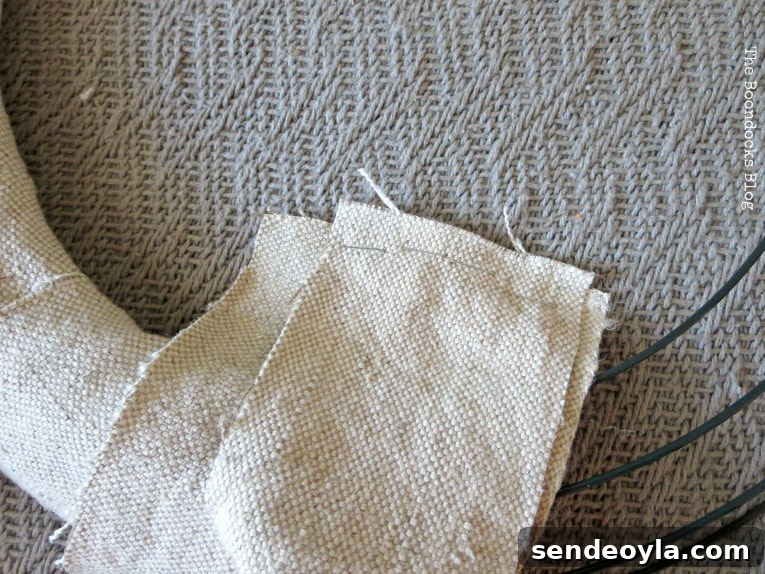 DIY Dollar Store Fall Wreath: Step-by-Step Guide 5 Stapled strips of fabric around the wire form.