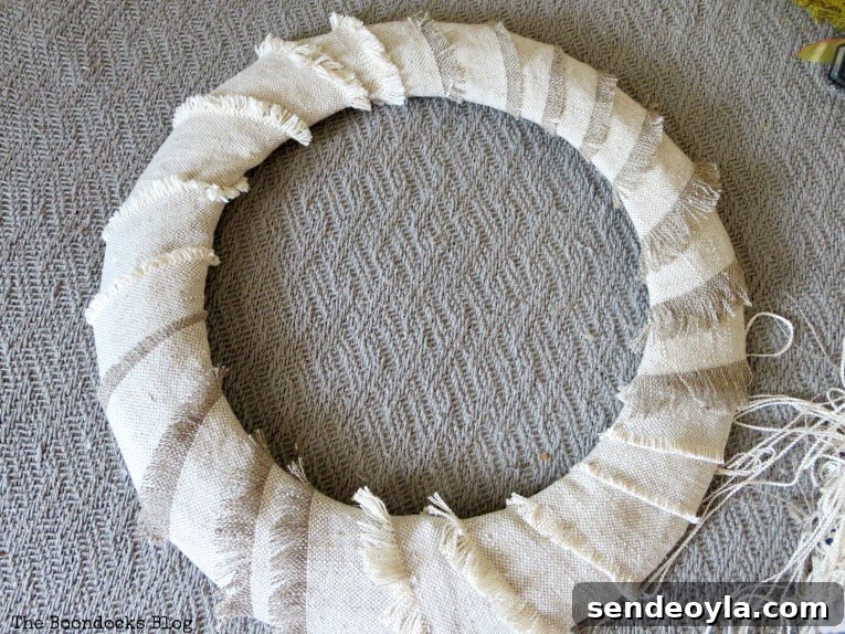 DIY Dollar Store Fall Wreath: Step-by-Step Guide 7 Strips of fabric wrapped around the wire form.