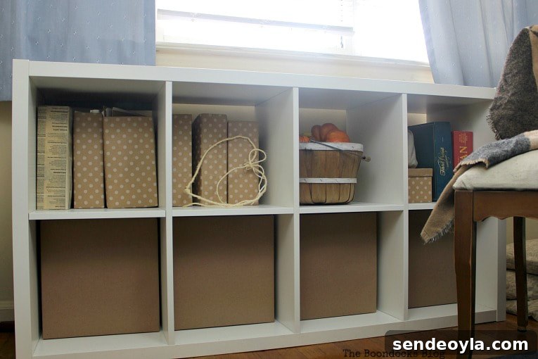DIY Cardboard Paper Organizer for Your Desk 12 Kallax storage bin holding cardboard paper boxes and a basket.
