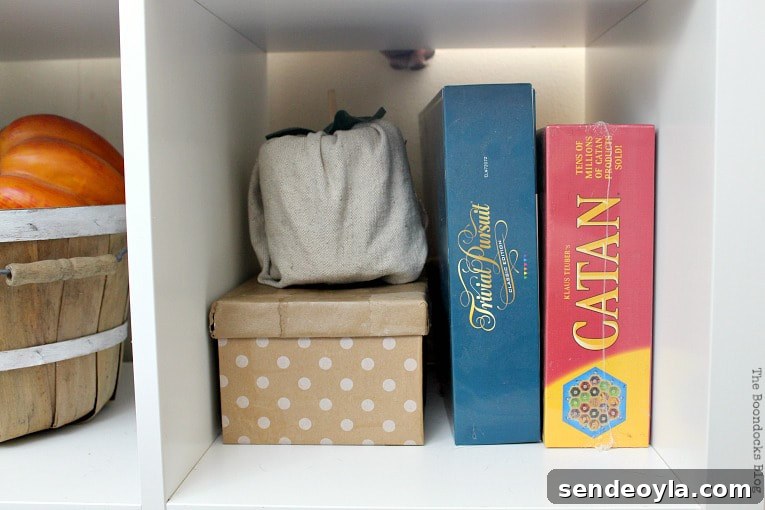 DIY Cardboard Paper Organizer for Your Desk 9 Shoe box covered in gift wrap paper next to board games.
