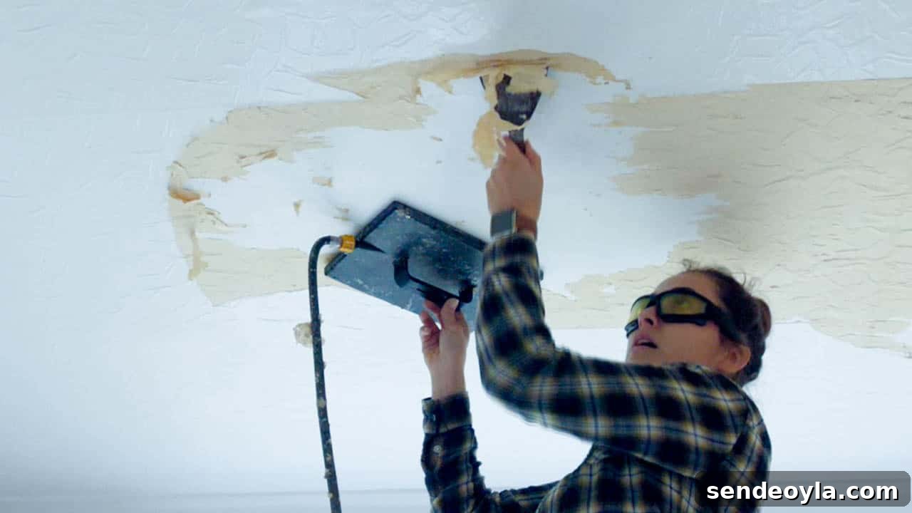 How to Use a Wallpaper Stripper to Remove Old Wallpaper 11 removing wallpaper with texture on the ceiling