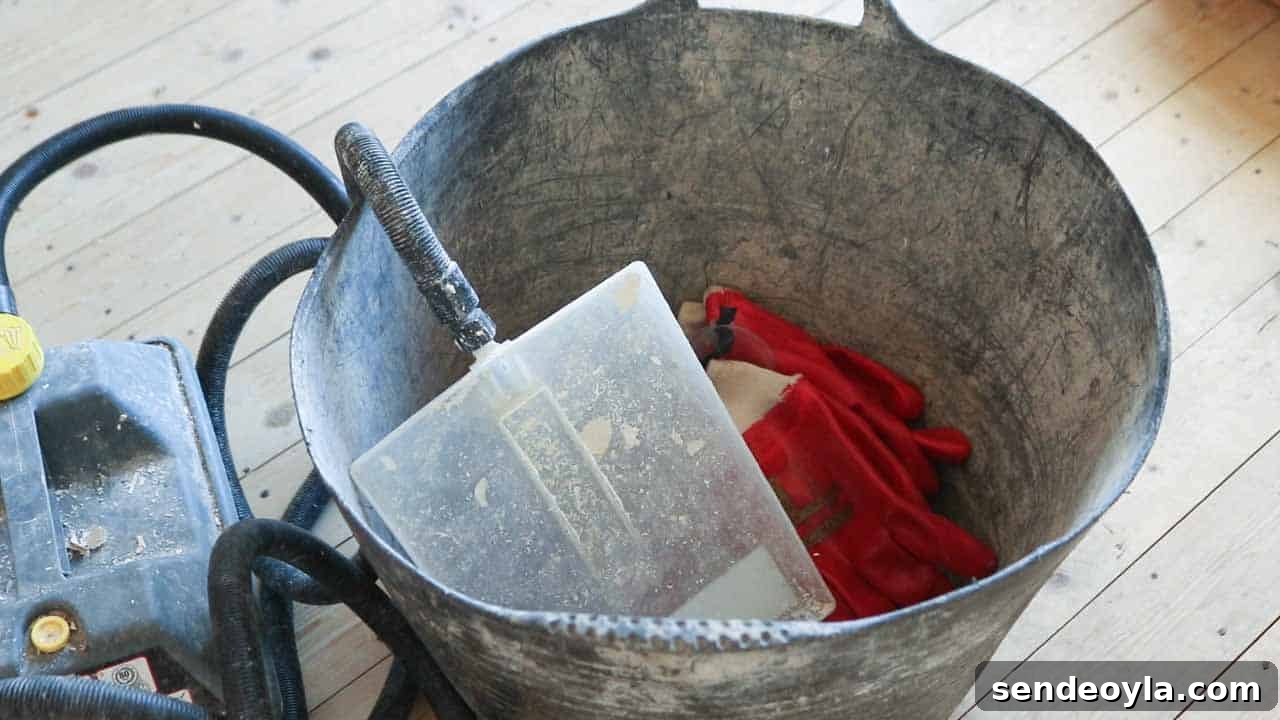 How to Use a Wallpaper Stripper to Remove Old Wallpaper 5 Staying safe with a wallpaper steamer stored upwards in a bucket