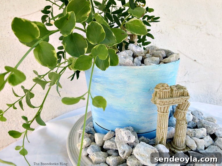 Upcycled Beach Vignette Ideas for Coastal Decor 17 planter with a beachy ancient ruin look, #beachysummerlook #ancientruins #beachyplanter #containerplanter #Mediterranean #plantervignette #pebblerockproject #vincavine #easyproject Using Pebbles to Inspire My Love of the Beach www.theboondocksblog.com