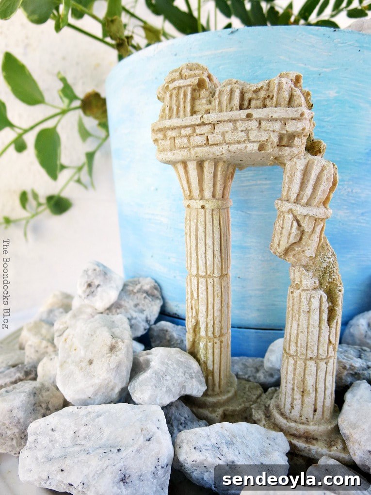 Upcycled Beach Vignette Ideas for Coastal Decor 18 planter with a beachy ancient ruin look, #beachysummerlook #ancientruins #beachyplanter #Mediterranean #plantervignette #containerplanter #pebblerockproject #vincavine #easyproject Using Pebbles to Inspire My Love of the Beach www.theboondocksblog.com
