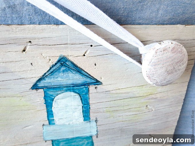 Coastal Wall Art Made from Repurposed Beach Finds 13 Knobs painted white to match whitewashed plywood