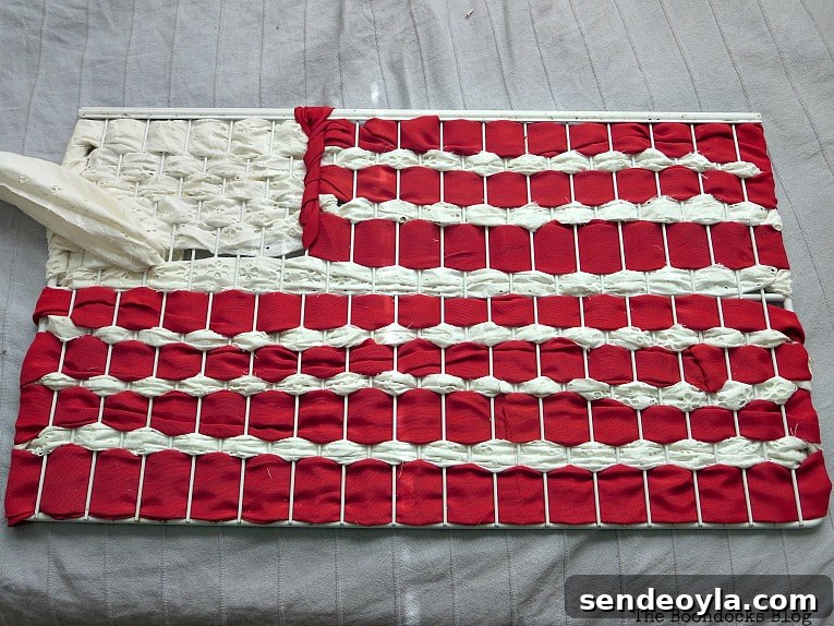 DIY Patriotic Fabric Scrap Projects for Fourth of July 7 Wire rack with fabric scraps weaved through to look like flag, How to Make Easy Patriotic Art with Fabric Scraps www.theboondocksblog.com