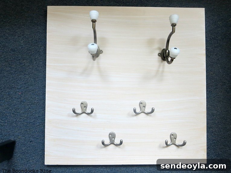 Attaching hooks to the painted plywood.