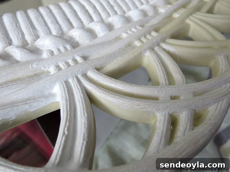 Detail of paint going on mirror white over the yellowish plastic