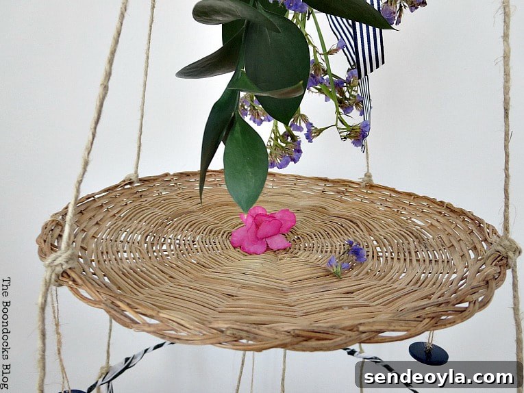 Flower bouquet hanging over the second tier of the mobile.