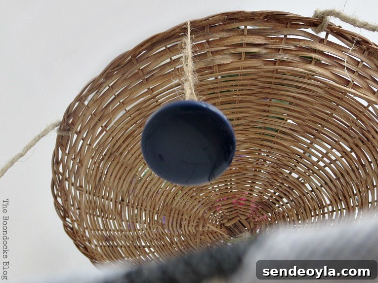 The second tier wicker plate charger, with a button hanging from the edge.