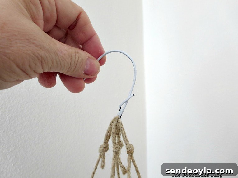 Creating a hook from the top of the wire hanger.