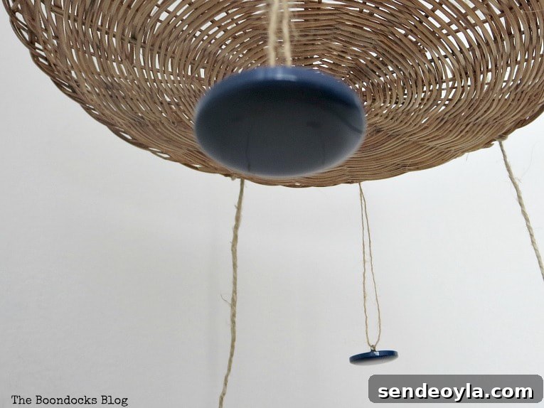 Adding buttons to the mobile with thin twine.