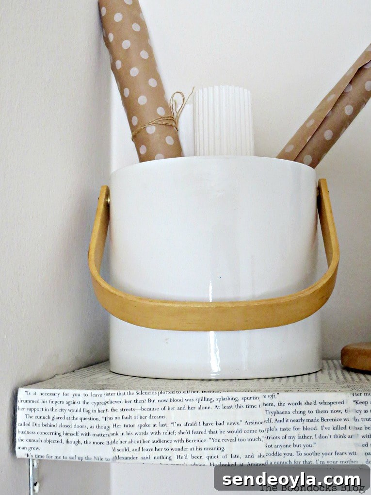 ice bucket repurposed to hold gift wrapping paper