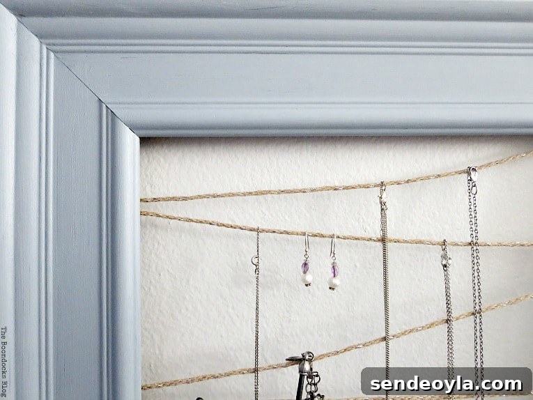 Close up of jewelry organizer made with frame and twine