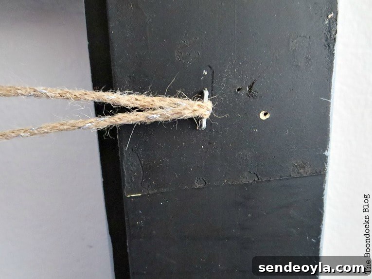 Twine passed through staple on back of frame