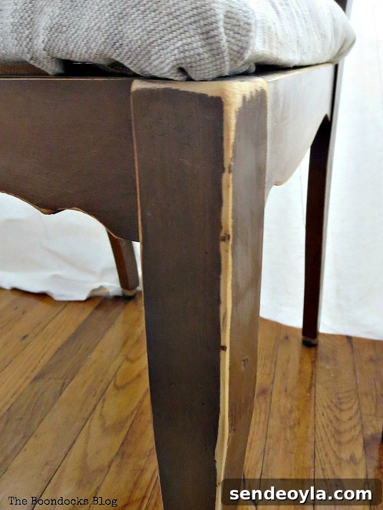 DIY: Turn One Chair Into Two Distinct Makeovers 10 distressed leg of finished wood chair, #Chairmakeover #Upcycledchair #Chalkytypepaint #Uniquelookforchair #upcycledclothes How to Get Two Unique Makeovers from One Chair www.theboondocksblog.com