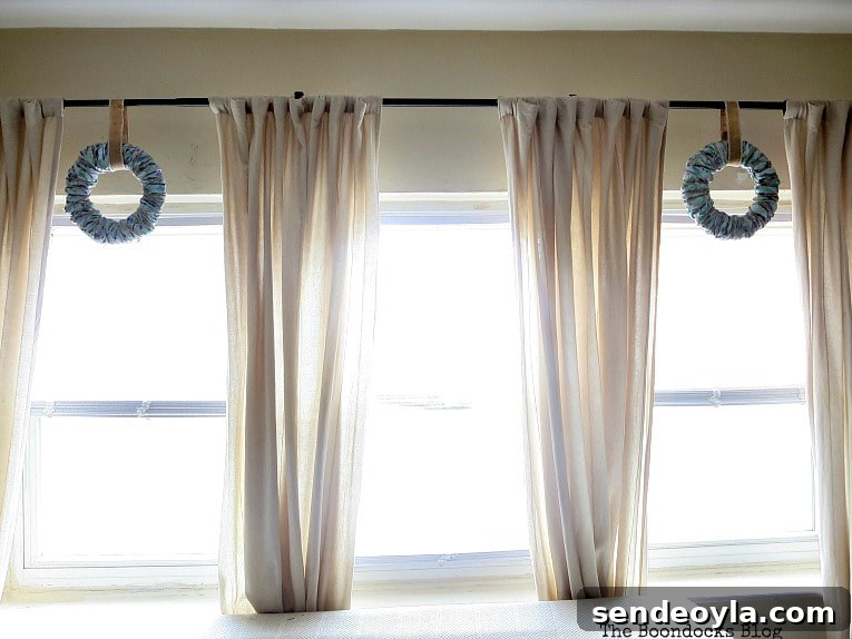 The two wreaths hung in the living room curtain rod.