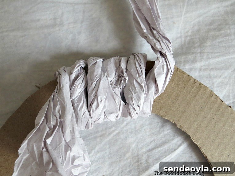 Wrapping the twisted paper around the cardboard piece.