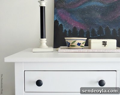 Refinish and Restore a Campaign Dresser in 7 Steps 21 Top of a white dresser.