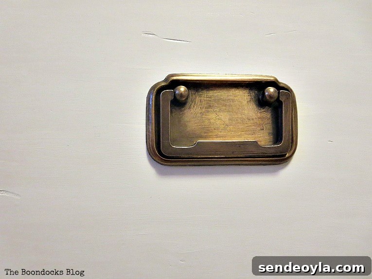 Refinish and Restore a Campaign Dresser in 7 Steps 7 Close up of brass handles.
