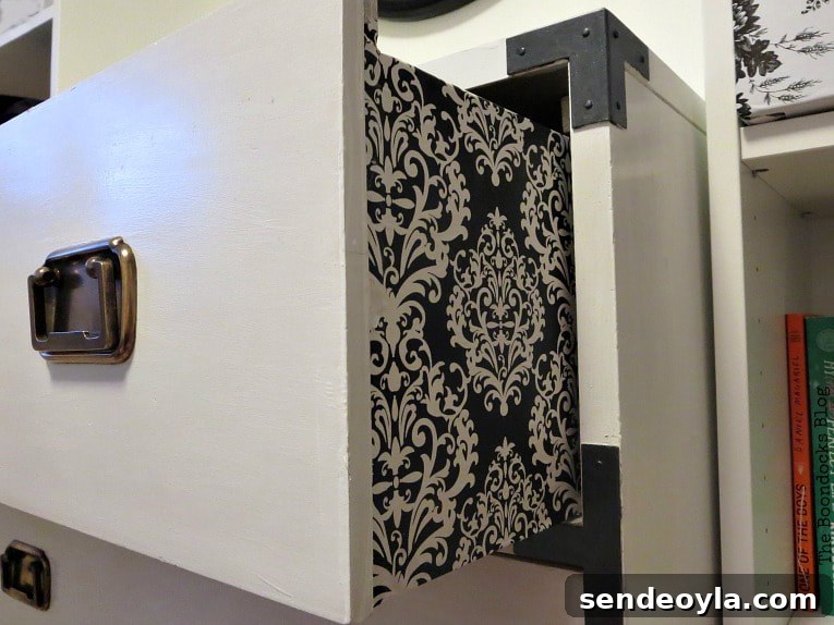Refinish and Restore a Campaign Dresser in 7 Steps 9 Toile wrapping paper on sides of drawer.