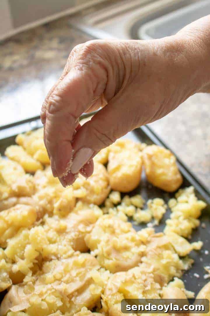 sprinkling Cornish sea salt on crushed new potatoes
