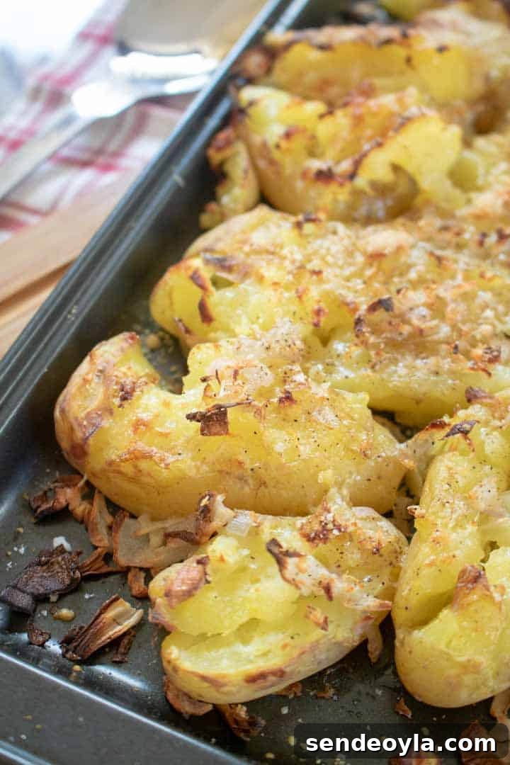 Crispy crushed potatoes on baking tray to serve with steak
