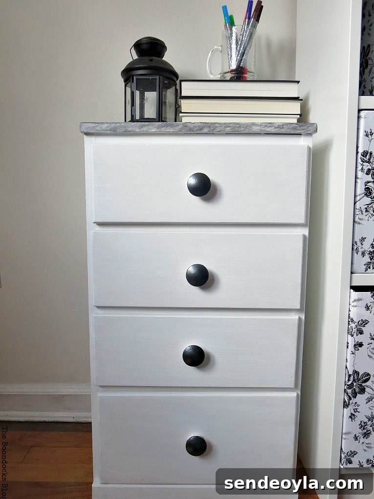 Finished nightstand makeover with paint, wood filler, metallic paint and contact paper.