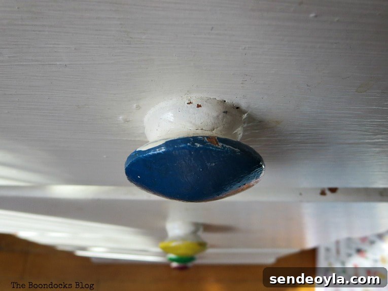 Chipped blue drawer knob.