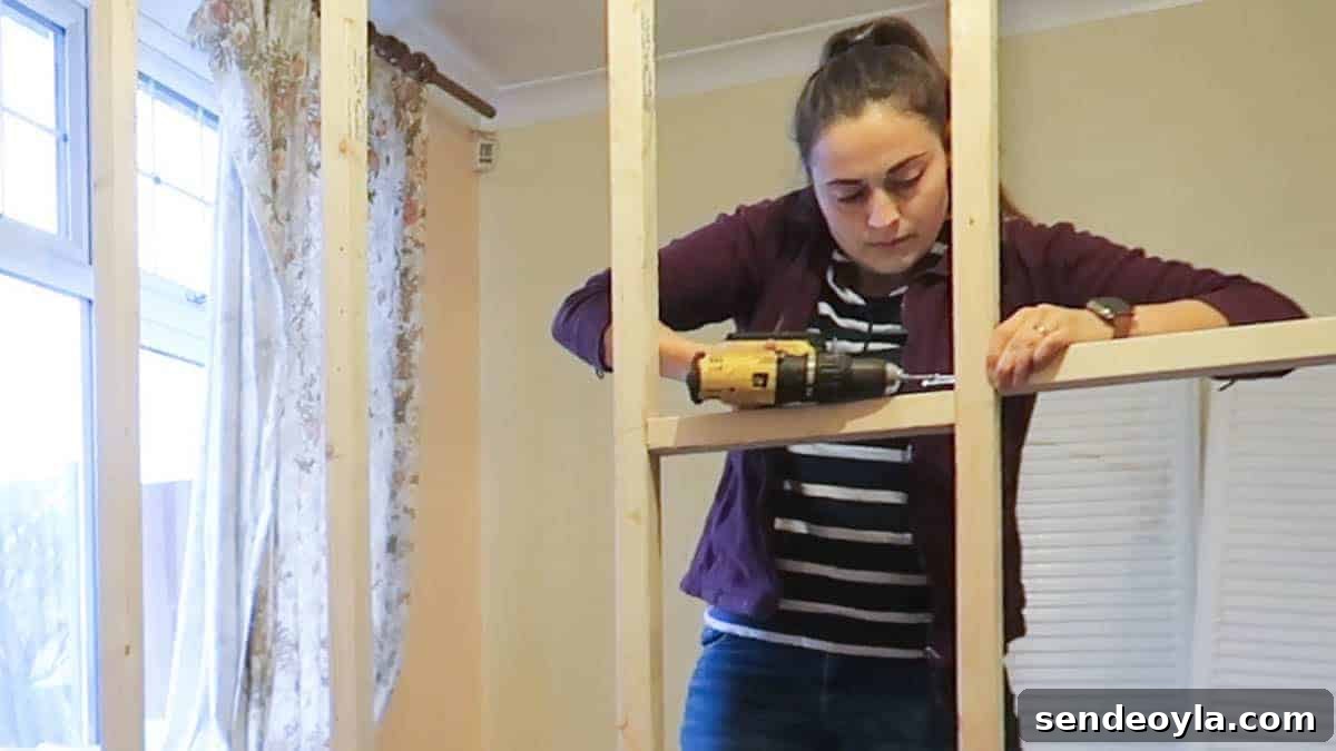 How to Build a Partition Wall: Step-by-Step DIY Guide 15 Screwing noggins in a studded wall