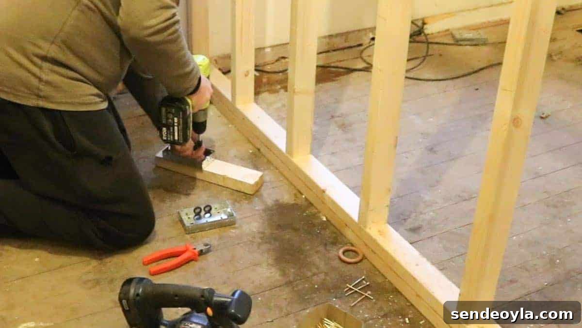 How to Build a Partition Wall: Step-by-Step DIY Guide 17 Mounting electrical plug sockets to noggins before adding plasterboard