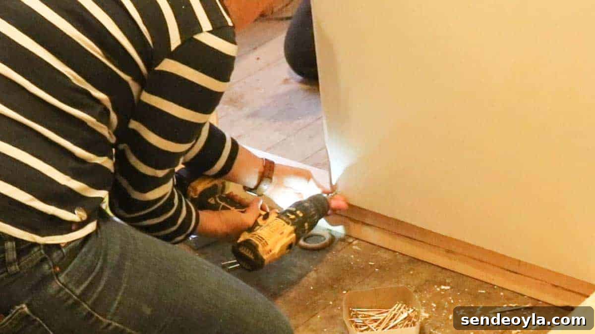 How to Build a Partition Wall: Step-by-Step DIY Guide 21 screwing plasterboard on a low torq setting with combi drill
