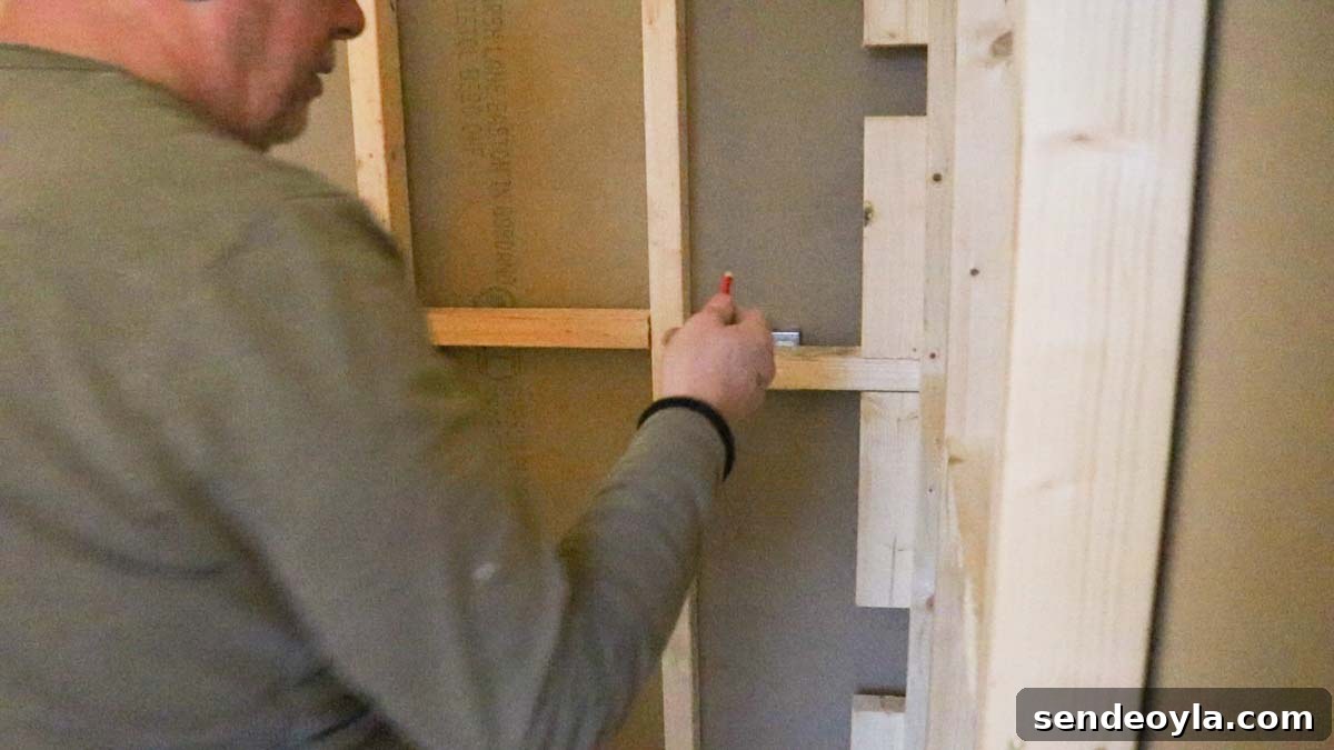 How to Build a Partition Wall: Step-by-Step DIY Guide 22 drawing around light switch from back of plasterboard