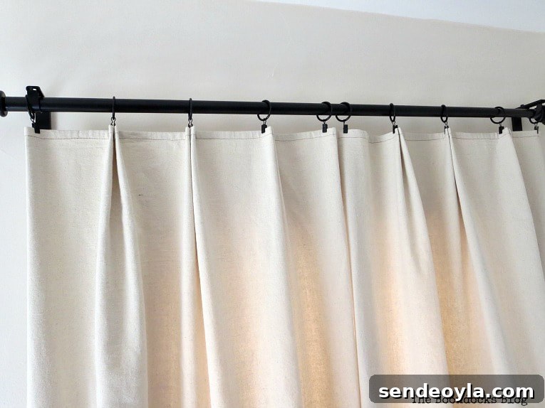 DIY Pleated Drop Cloth Curtains: Step-by-Step Guide 8 Pleated drop cloth curtain hanging on rod