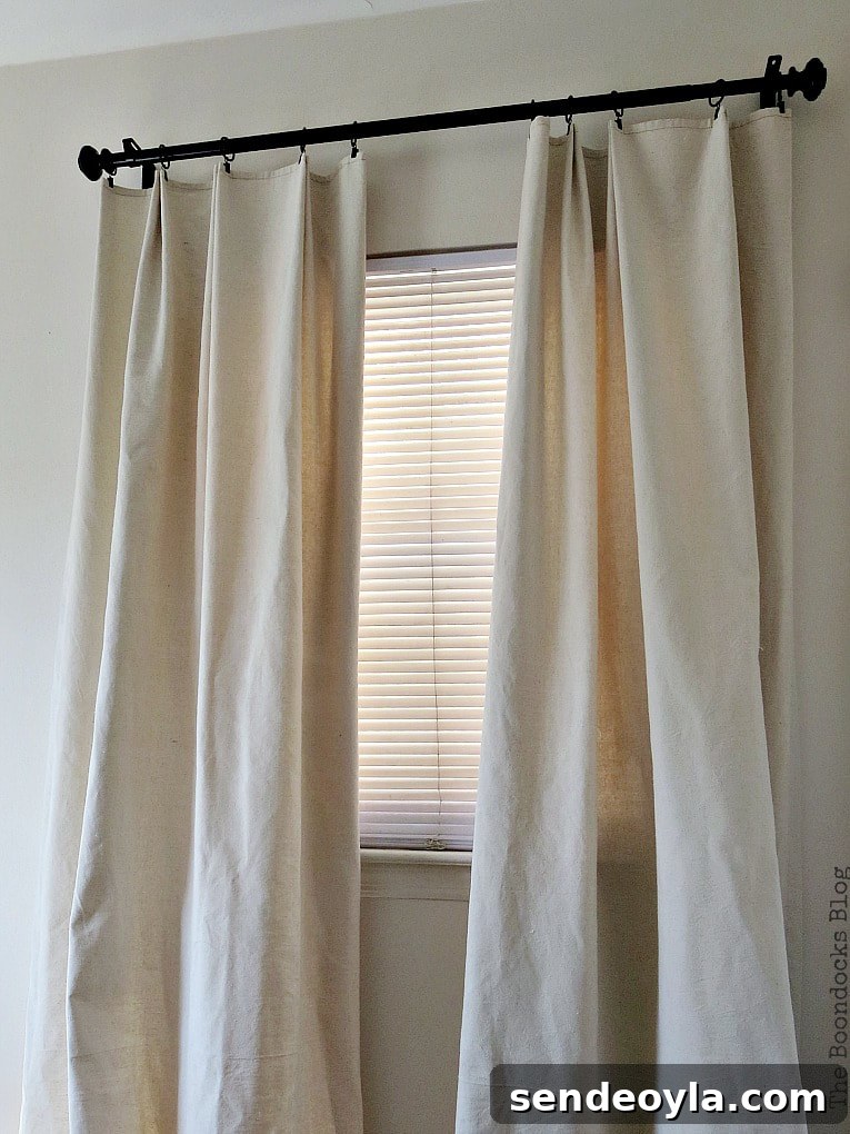 DIY Pleated Drop Cloth Curtains: Step-by-Step Guide 11 Small window that looks larger with high and wide curtain placement