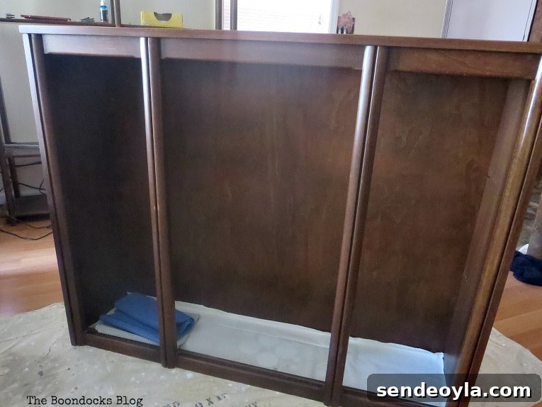 Adding Tung oil to the top part of the china cabinet.