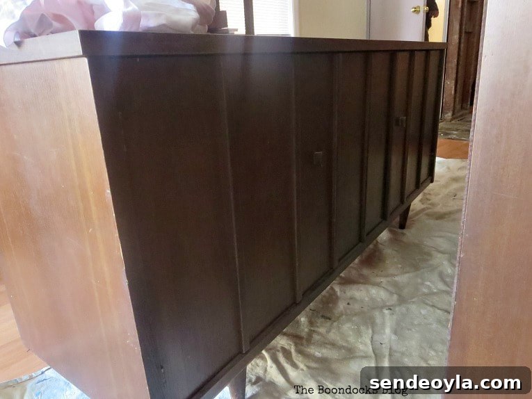 Adding tung oil to the bottom part of the china cabinet.