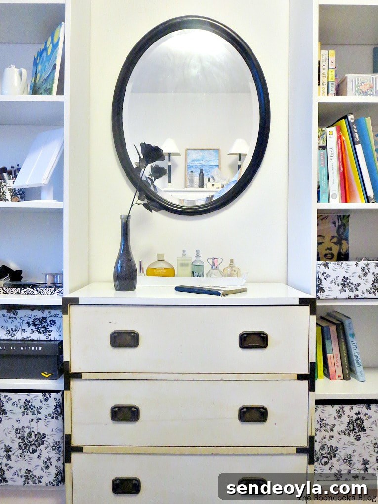 Black painted mirror over dresser and flanked by bookcases, How to Revive an Old Wood Mirror with Paint www.theboondocksblog.com