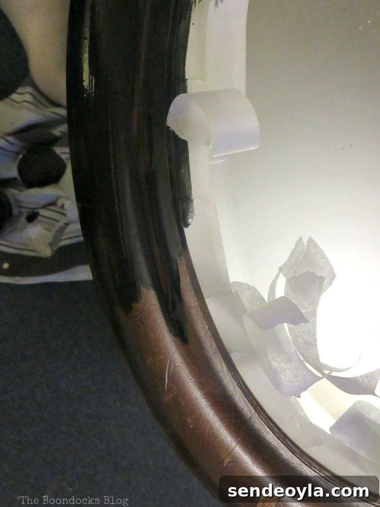 masking tape around the mirror, How to Revive an Old Wood Mirror with Paint www.theboondocksblog.com