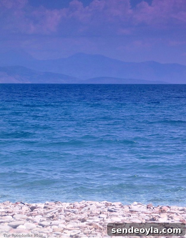 Step-by-Step Impressionist Painting Tutorial for Beginners 7 Photo of pebbles, sea and mountains with sky in the background, How to Make your Own Impressionist Art Painting www.theboondocksblog.com