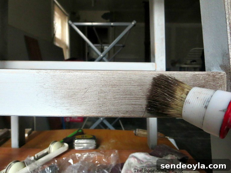 Adding the dark wax with the round brush.