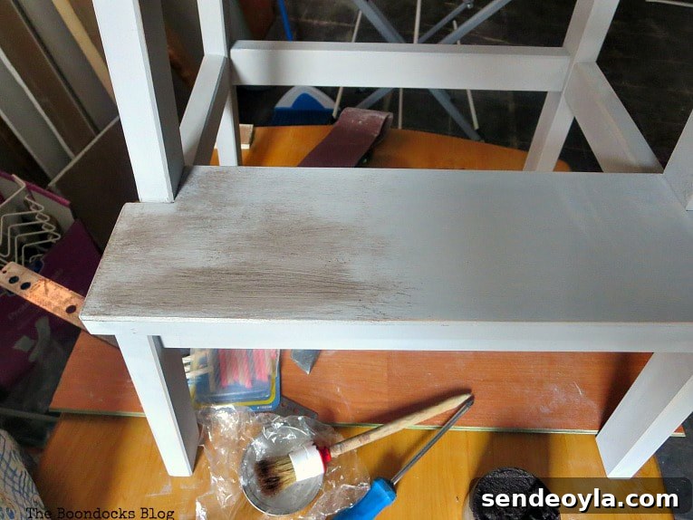 Adding the dark wax on top of the cream wax on the stool.