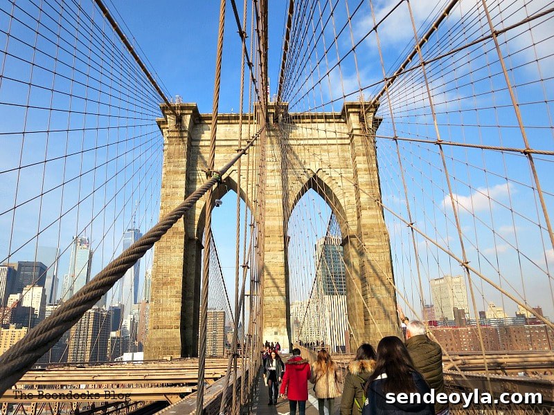 The walkway with tourists and native New Yorkers, A Tour of the Astonishing Brooklyn Bridge Walkway www.theboondocksblog.com