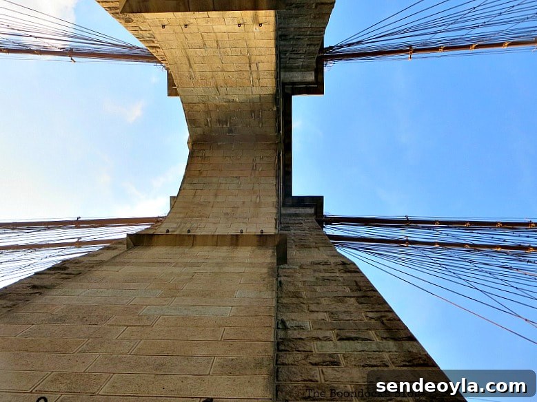 Standing underneath one of the Towers of the Brooklyn Bridge, A Tour of the Astonishing Brooklyn Bridge Walkway www.theboondocksblog.com
