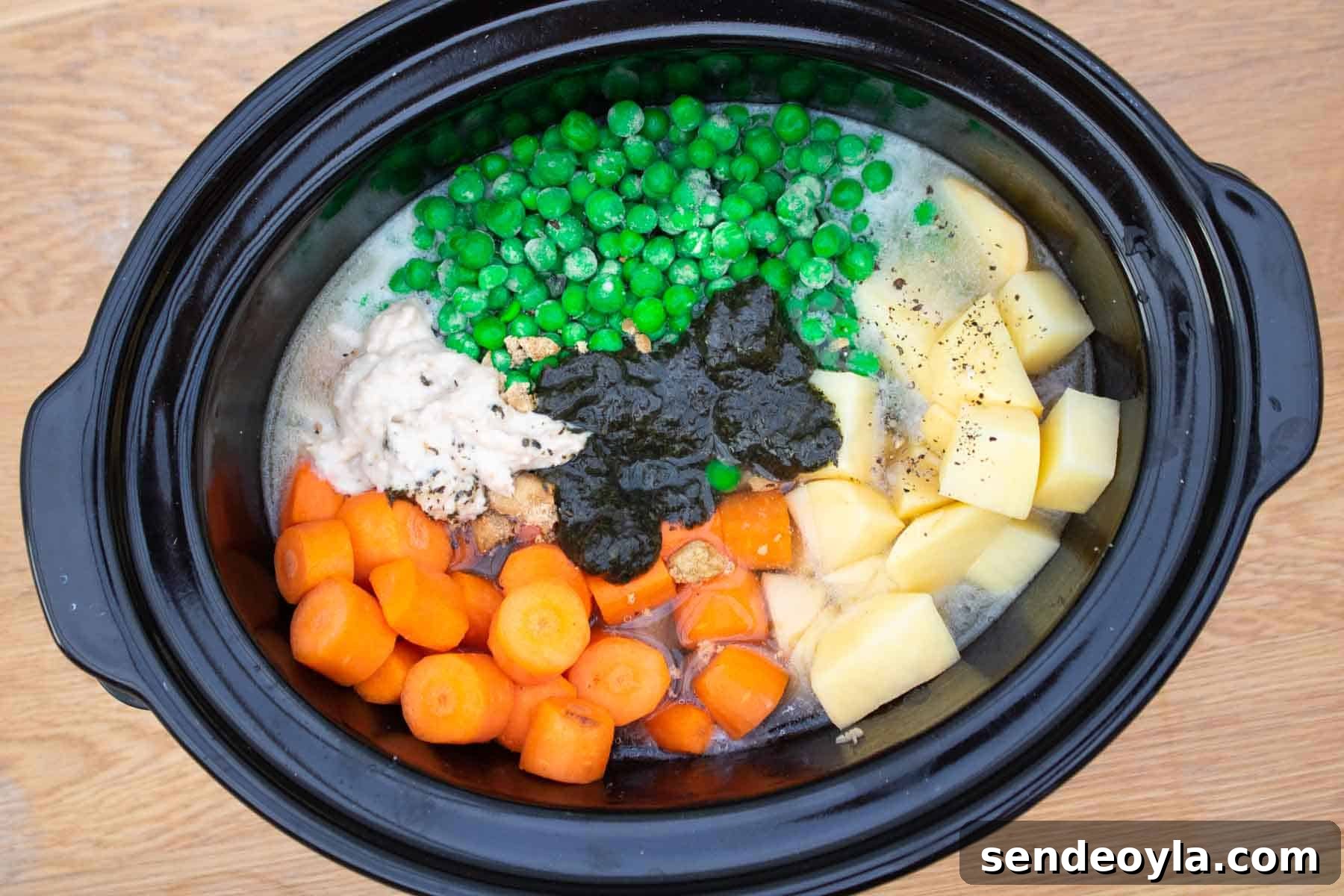 Slow Cooker Minted Lamb Stew with Dumplings 5 Raw lamb casserole ingredients in a slow cooker before turning on.
