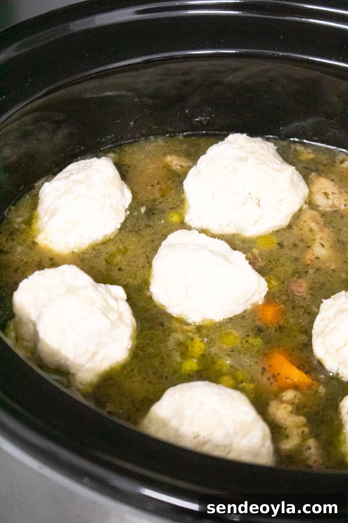 Slow Cooker Minted Lamb Stew with Dumplings 8 homemade English dumplings recipe placed in a slow cooker on a lamb stew