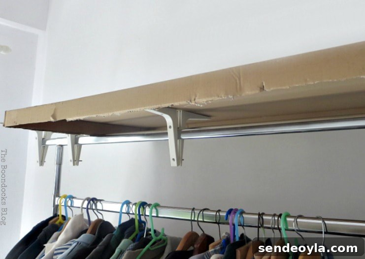 DIY Clothes Rack Cover: Step-by-Step Guide 5 The clothes rack with brackets and cardboard on top.